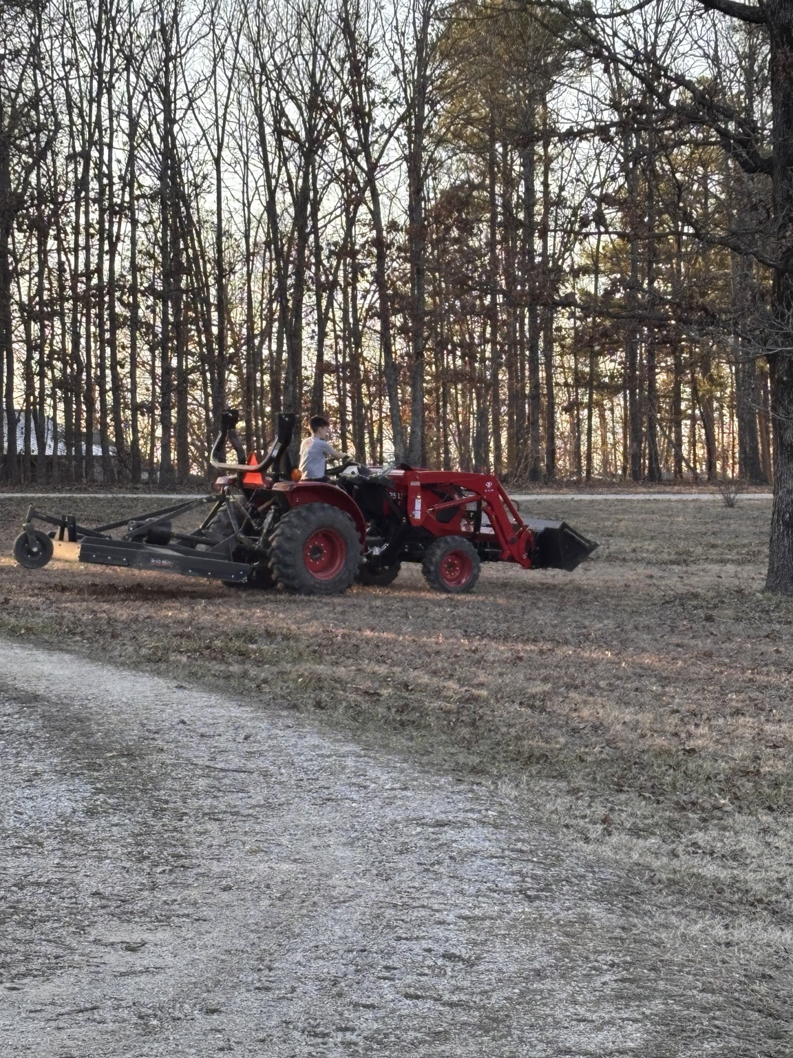 Tractor and brush hog working on a Southeast Missouri property